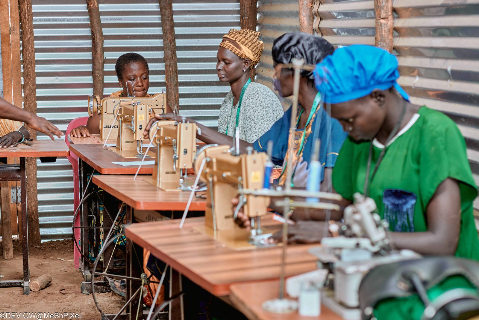 Young girls and women learning tailoring together